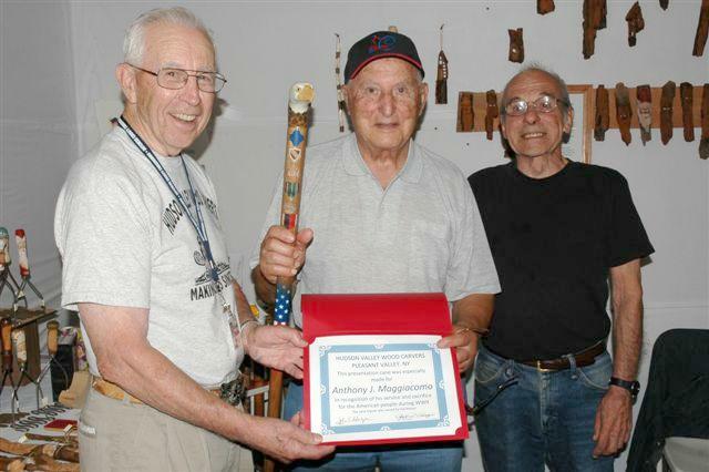 Army T4 Tony Maggiacomo (Center). Cane carved by Hal Weisel of HVWC. Presented by Hal Weisel.