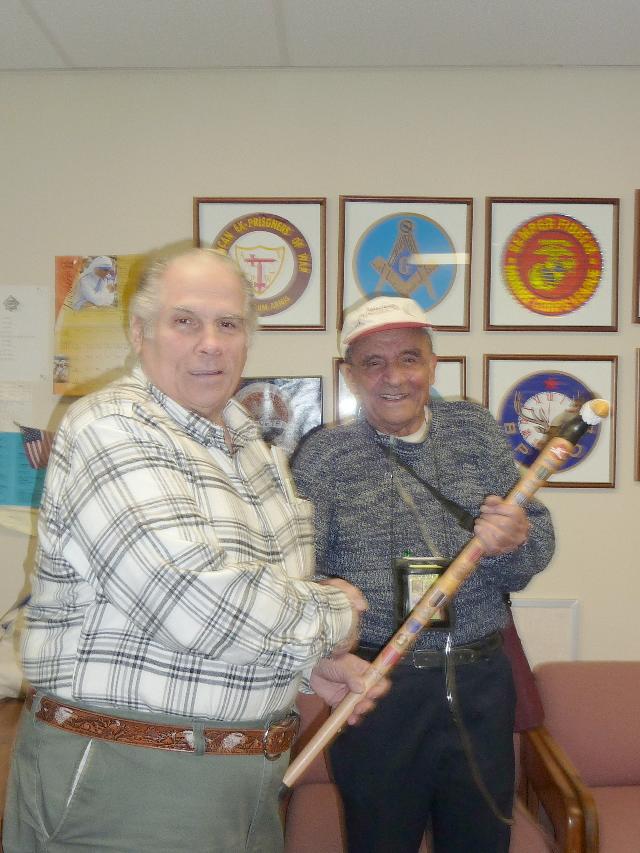 Army Vincent J LoGiudice. Cane carved by Pat Paraggio of HVWC. Presented by Pat Paraggio (left) of HVWC.